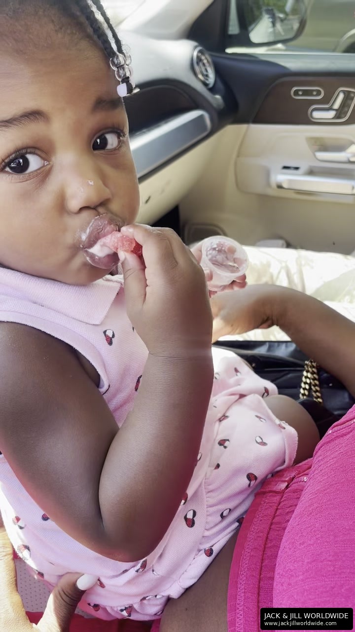 Baby tasting a Jack & Jill watermelon fry in a car seat