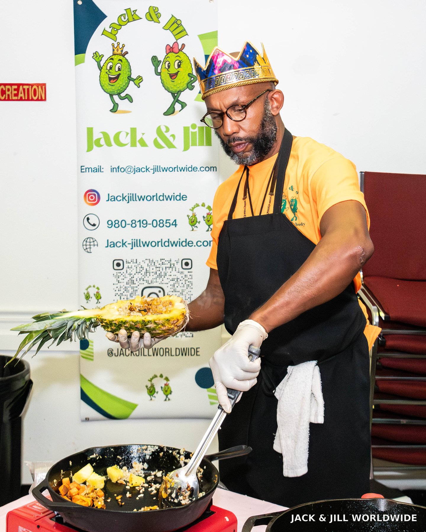 Shundo preparing a dish beside Jack & Jill Worldwide branding